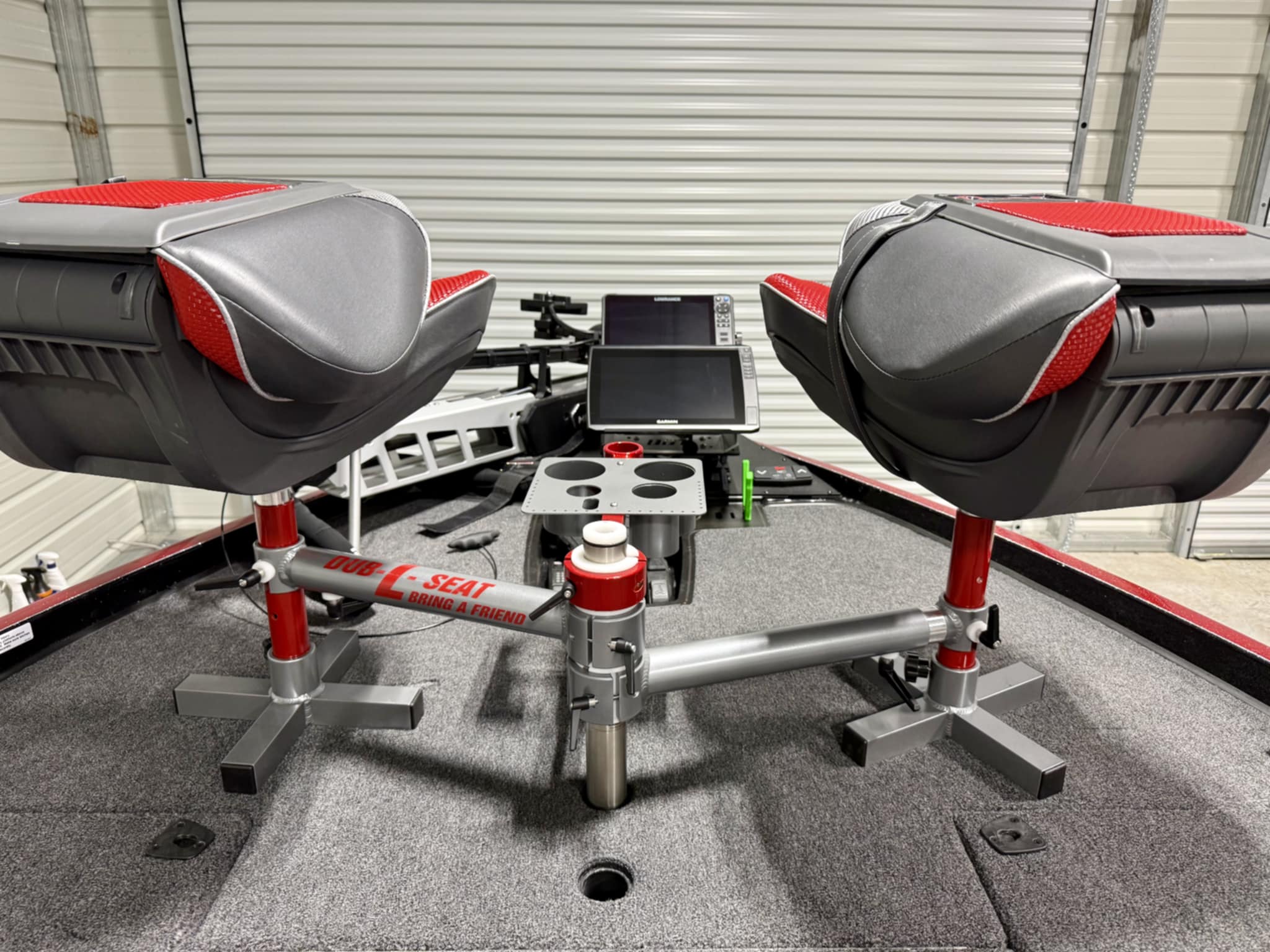 Dub-L-Seat dual fishing seat system installed on bass boat bow with Garmin fish finders